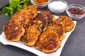 Meat dish cutlets with vegetables in white plate