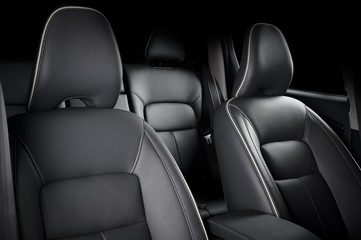 Luxury car inside. Interior of prestige modern car. Comfortable leather seats. Black perforarated leather cockpit.