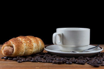 Breakfast with coffee and sausage dough on wooden table