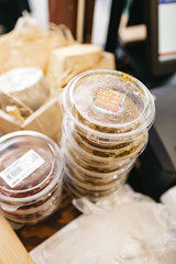 Plastic bowls with cheese stand on the shopboard