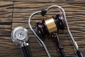Stethoscope And Gavel On Wooden Desk