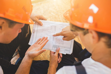 Two man building wooden house