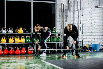 Fototapeta premium the girl is getting ready for the exercise with the trainer