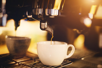 A cup of coffee straight from a coffee machine.