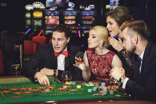 Young and rich people playing roulette in the casino