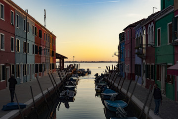 Fototapeta na wymiar An old fishermen village called Burano, next to Venice, has its houses traditionally painted in bright colors to help fishermen find back their home when it`s bad weather and theygetting back home