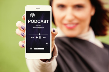 Woman showing mobile phone with podcast app in the screen.