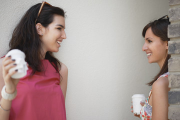 Two girls standing in passage and drinking coffee