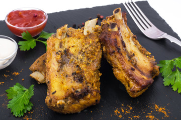 Pork ribs on black stone plate