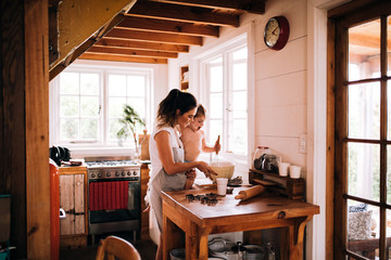 Caucasian mother and son baking cookies in kitchen together