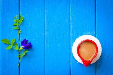 Good morning word,Retro Clock with cup  of coffee on blue background,empty space