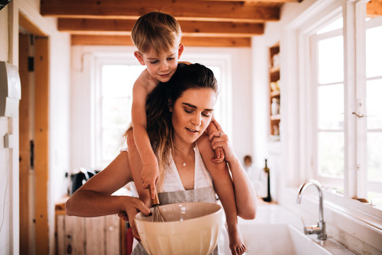 Mother and son baking together in kitchen