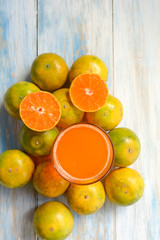 Top view of Orange and orange juice on blue background.