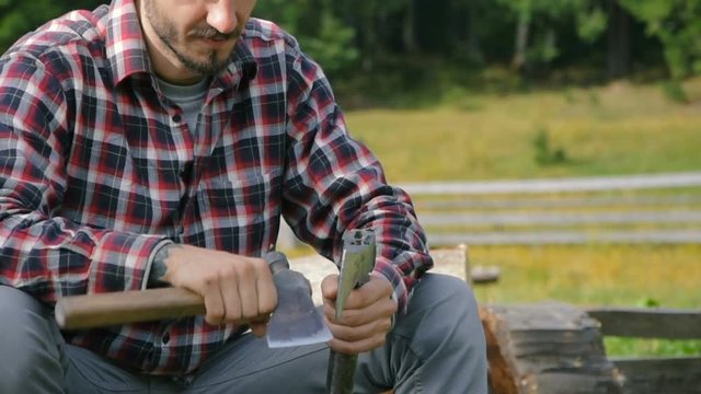 man sharpening an axe