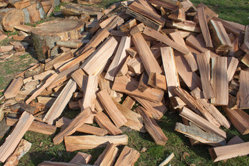 Firewood background - chopped firewood on a stack. Dry chopped firewood logs in a pile