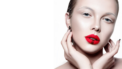 Beautiful woman portrait with white skin, red lips and hands on face.