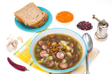 Dish from lentils, vegetables and sausages