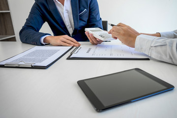 Businessman being analysis and making the decision a car insurance policy, Agent man is holding the calculator and waiting for his reply to finish