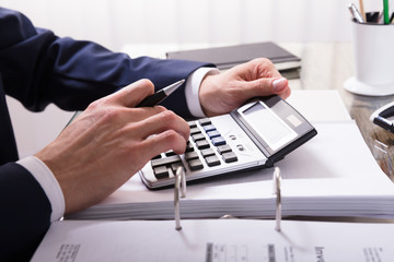 Businessperson Calculating Bill