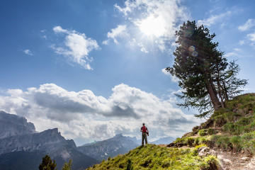 Man watching beautiful dolomitic landscape, Valparola Pass, Dolomites, Italy