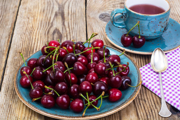 Cherry compote and fresh cherry on plate
