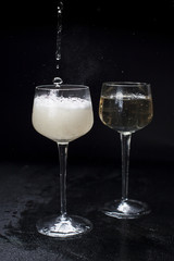 two glasses with champagne. On a black background