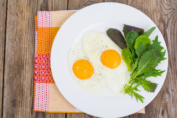 Breakfast. Fresh salad leaves and two fried eggs