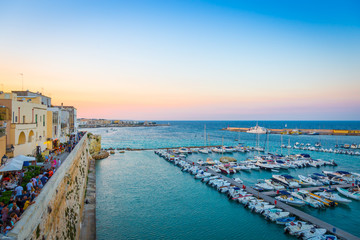 OTRANTO, ITALY - AUGUST 23, 2017 - panoramic view from the old town at sunset during turistic season - obrazy, fototapety, plakaty