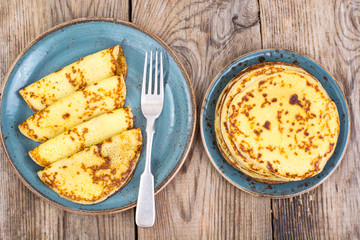 Pancakes stuffed with chocolate sauce, for breakfast on wooden table