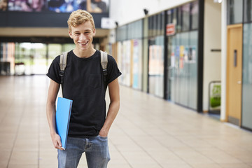 Fototapeta premium Portrait Of Male Student Standing In College Building