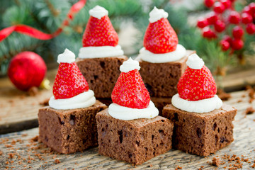 Santa hat brownie, Christmas dessert, chocolate pieces with strawberry and cream