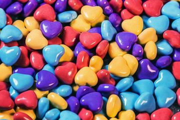 Fototapeta na wymiar chewable candies of different colors in the shape of hearts background