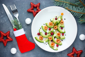 Fototapeta na wymiar Christmas tree appetizer avocado salmon salad tartare ceviche