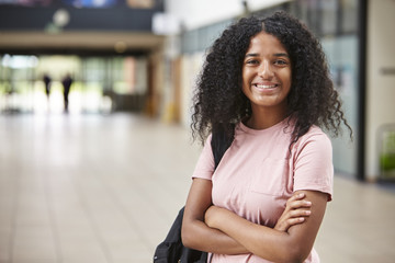 Fototapeta premium Portrait Of Female Student Standing In College Building