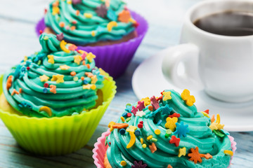 cakes cupcakes to the celebration of Christmas on the wooden table, and a Cup of hot coffee