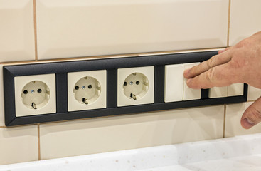 hand disables or enables the electricity in the room with ceramic tiles