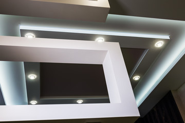 suspended ceiling and drywall construction in the decoration of the apartment or house. focus on the spot