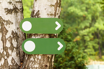 Direction indicator on the tree in the forest