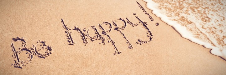 Be happy written on sand