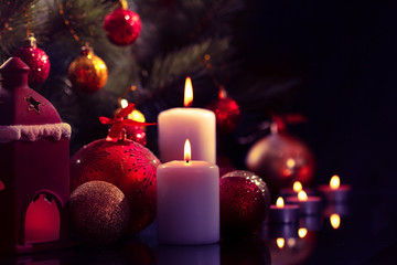 Burning candle on Christmas tree.