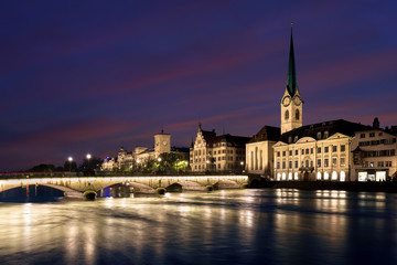Obraz premium View of historic Zurich city center with famous Fraumunster Church and river Limmat at Lake Zurich , in twilight, Canton of Zurich, Switzerland.