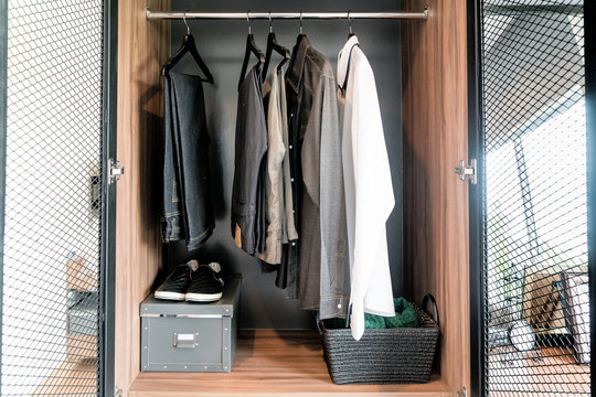 Modern Interior Man Wardrobe With Shirt, Pants And Shoes In Shelf.