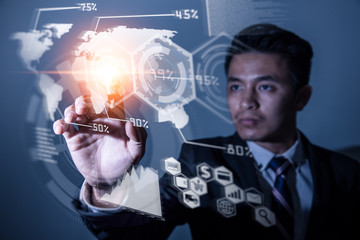 The abstract image of the business man point to the business virtual hologram through the computer screen. the concept of communication network, cyber security, internet of things and future life.