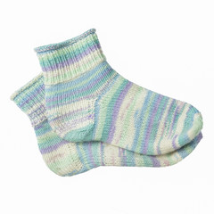 Homemade knitted wool melange socks on a white background