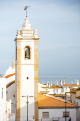 Cityscape view on the old town with beautiful white houses and bell tower in Albufeira city on the south of Portugal