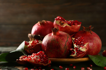 Red pomegranates closeup on dark