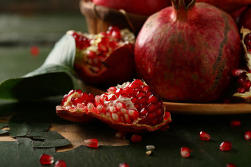 fresh pomegranates closeup on green background