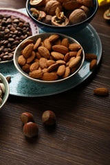 Mixed nuts and almond on wood background