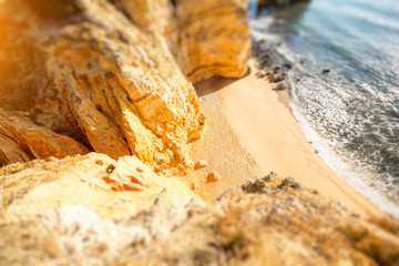 Top view on the beautiful sandy beach on the Ponta da Piedade near the Lagos city in Portugal. Tilt-shift image technic