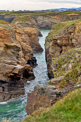 View of Cathedrals beach natural rock formations  in Ribadeo, Spain, with high tide.